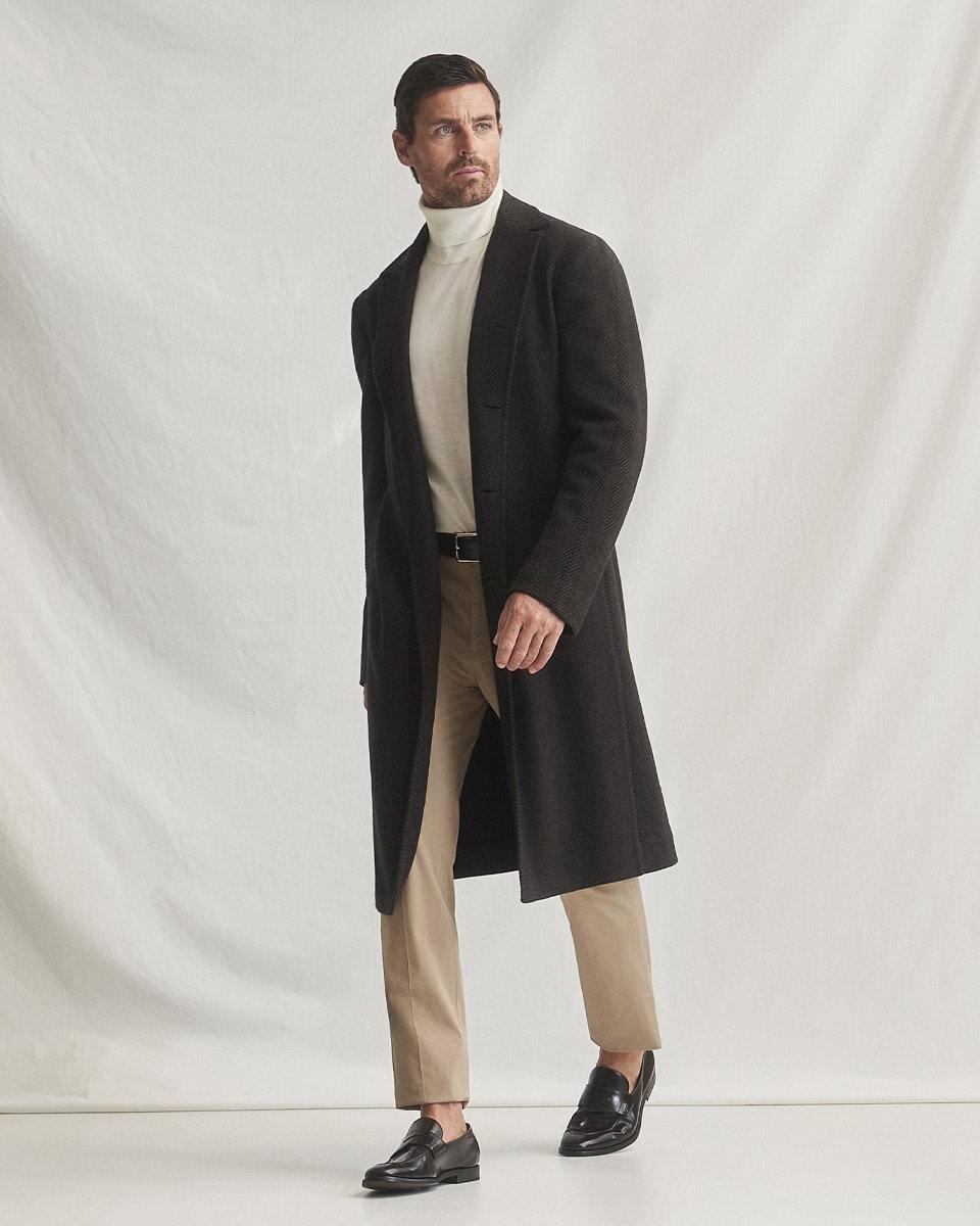Close editorial view of a dark textured tailored coat